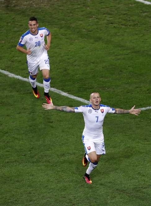 Slovakia's Vladimir Weiss, right, celebrates (AP Photo/Darko Vojinovic)