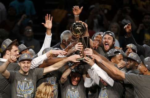 The Golden State Warriors celebrate with the Larry O'Brien Trophy after defeating the Cleveland Cavaliers in game six of the 2015 NBA Finals . Photo: AP
