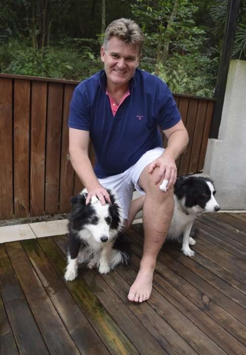 Karl Davies back home with his dogs Polly and Ziggy following the attack on him by a 3.5 metre Burmese python.