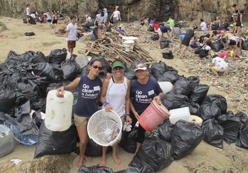 Gweilo volunteers lead the way in cleaning up a beach in Hong Kong. Photo: SCMP Pictures