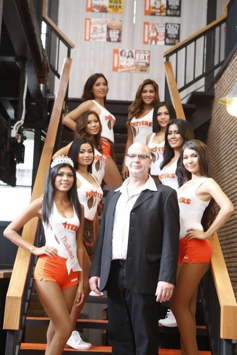 Mike Warde, general manager of Hooters Asia, with some of his employees in Thailand.