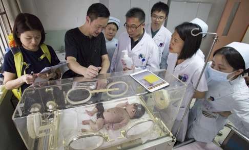 Dr Ngan with a baby following surgery.