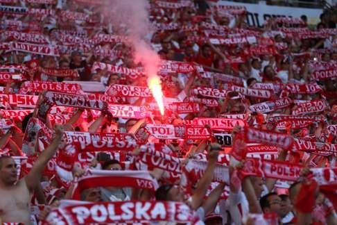Poland supporters light a flare EPA/OLIVER WEIKEN
