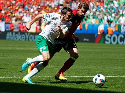 Ireland's Seamus Coleman, left, fights for the ball with Belgium's Jan Vertonghen . (AP Photo/Hassan Ammar)