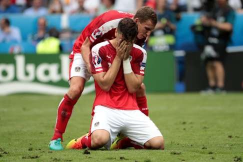 Austria's defender Aleksandar Dragovic reacts after missing a penalty AFP PHOTO / KENZO TRIBOUILLARD