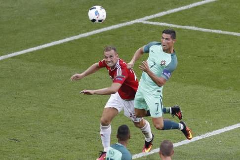 Cristiano Ronaldo heads in his side’s third. (AP Photo/Michael Sohn)