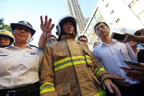 (L to R) Superintendent Lai Pik-ngor; Deputy Chief Fire Officer Kong Ping-lam; Director of Buildings Hui Siu-wai, appear as the blaze in the Ngau Tau Kok industrial building continues. Photo: Edward Wong