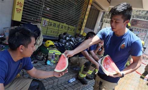 Welcome refreshment for firemen at the scene. Photo: Dickson Lee