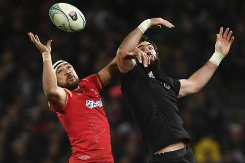 Taulupe Faletau of Wales and New Zealand's Sam Whitelock battle for the ball at a line-out.