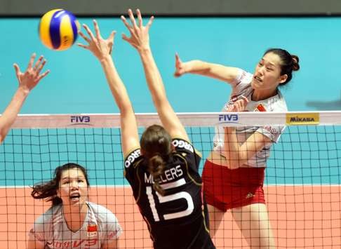 Germany’s Lena Moellers protects the net against Liu Xiantong’s spike while China teammate Yang Fangxu.