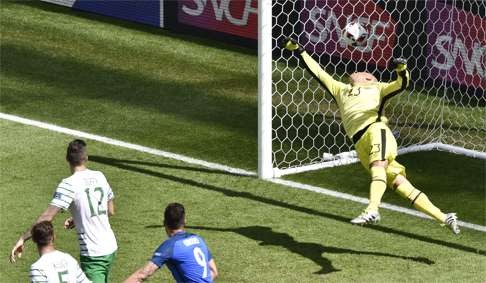 Antoine Griezmann (not pictured) heads the ball to score a goal past Ireland's goalkeeper Darren Randolph AFP PHOTO / JEAN-PHILIPPE KSIAZEK