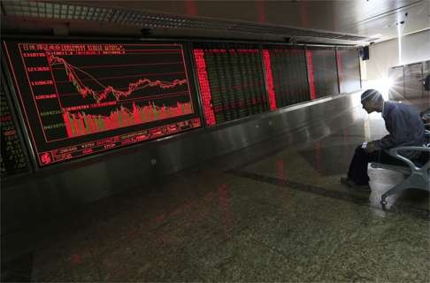 A screen shows stock market movements at a brokerage in Beijing on Friday. Chinese mainland markets traded lower in reaction to the British referendum result. Photo: EPA