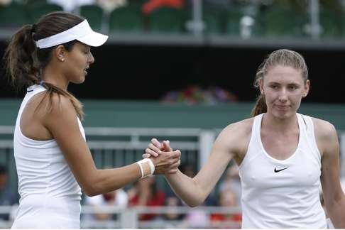 Former world No 1 Ana Ivanovic of Serbia (left) shakes hands with Ekaterina Alexandrova after the Russian stunned Ivanovic to win 6-2, 7-5 in the first round. Photo: AFP
