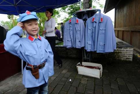 A child in a Red Army uniform salutes at the starting point of the Long March, in Ruijin, in Jiangxi province. Picture: Xinhua