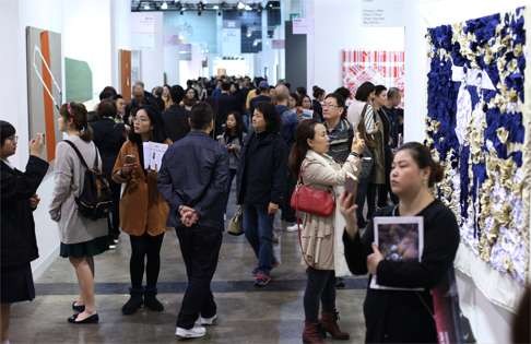 Visitors look at works during this year’s Art Basel in Hong Kong. Photo: Nora Tam