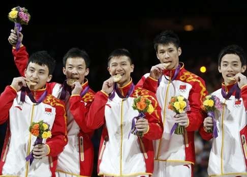 Chinese gymnasts pose with medals at the 2012 London Olympics. Photo: AFP