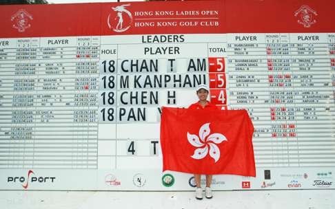 Tiffany Chan Tsz-ching poses in front of the scoreboard after her victory at the Hong Kong Ladies Open.