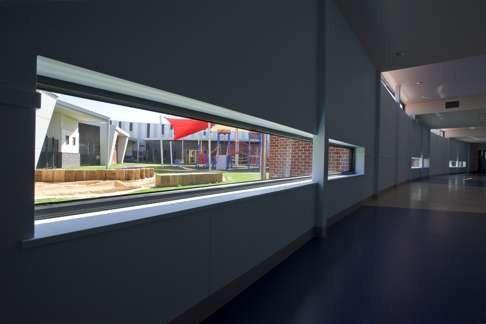 Curved corridors and playground-view windows at the Northern School for Autism in Melbourne. Photo: Hede Architects