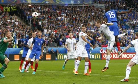 France's Paul Pogba scores with a header. Photo: AP