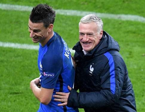 France’s Laurent Koscielny is embraced by coach Didier Deschamps after being substituted. Photo: EPA
