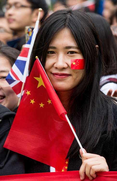 A Chinese student shows her support for President Xi Jinping during his visit to Manchester, England in October last year. Photo: AFP