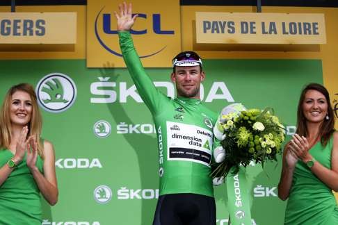 Mark Cavendish celebrates on the podium, wearing the best sprinter's green jersey. Photo: EPA