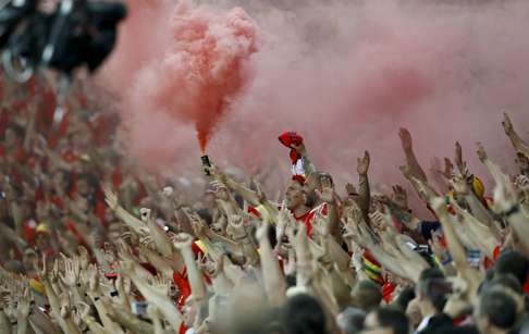 Wales' fans light a smoke bomb at the end of the match (AP Photo/Frank Augstein)