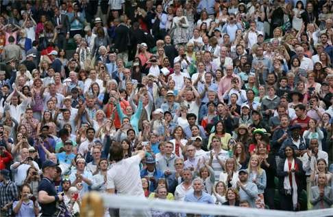 Andy Murray throws his wrist bands to the Centre Court crowd. Photo: AP