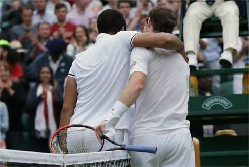 Andy Murray gives Jo-Wilfried Tsonga a hug after the match. Photo: AP