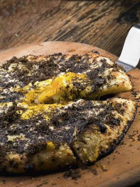 Black truffle, three cheeses and farm egg pizza.