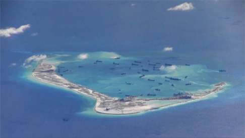Chinese dredging vessels are purportedly seen in the waters around Mischief Reef in the Spratly Islands in this still image taken from a video by a P-8A Poseidon surveillance aircraft provided by the US Navy last year. Photo: Reuters