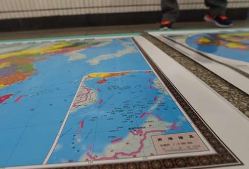 A map of China being sold on the streets of Beijing includes an insert with red dotted lines showing China's claimed territory in the South China Sea. Photo: AFP