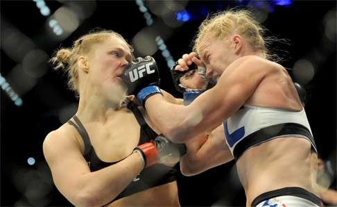 Holly Holm strikes Ronda Rousey (left) in November 2015 in Melbourne. Photo: EPA