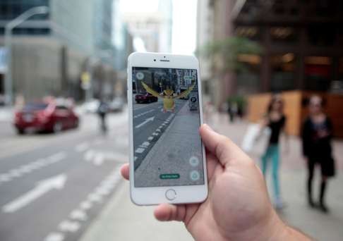 A “Pidgey” Pokemon is seen lurking on a Toronto street, overlaid on the screen of the Pokemon Go mobile app, Nintendo's new scavenger hunt game which utilizes geo-positioning to bring the hunt for Pokemon monsters into the real world. Photo: Reuters