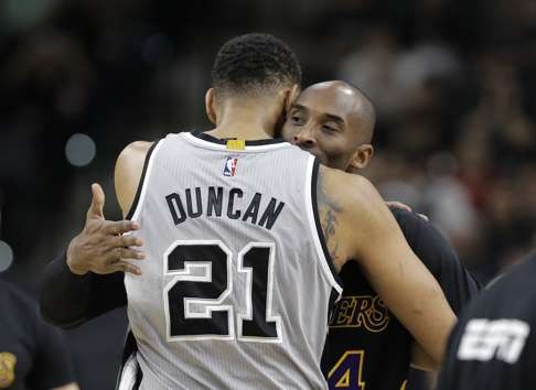 In this Dec. 11, 2015, file photo, Tim Duncan hugs Kobe Bryant. (AP Photo/Eric Gay, FIle)