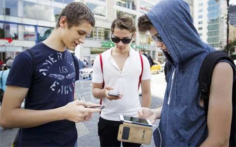 A group of people play the new game 'Pokémon Go' on their smartphones in Union Square in New York on Monday. Photo: EPA