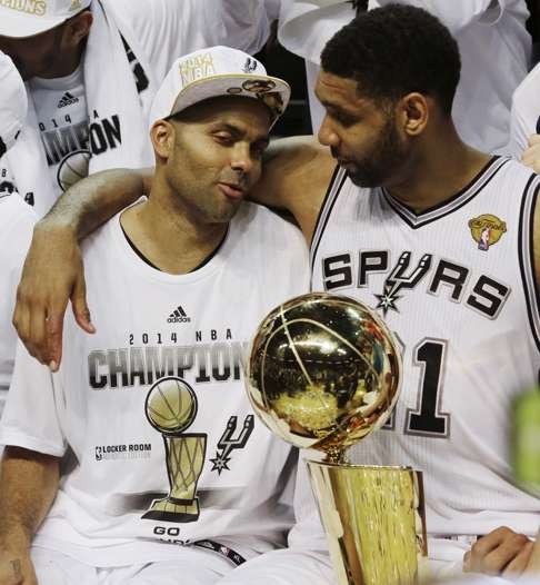 Spurs guard Tony Parker, left, and forward Tim Duncan celebrate after Game 5 of the NBA basketball finals in San Antonio in 2014. (AP Photo/David J. Phillip, File)