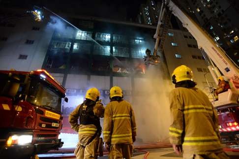 Firefighters work at the site of an industrial park in Kowloon on June 21, 2016. Photo: Xinhua