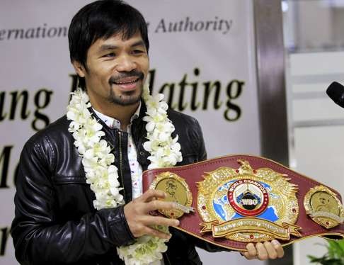 Manny Pacquiao shows his WBO championship belt after defeating Timothy Bradley in April. Photo: Reuters