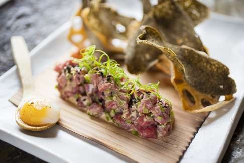 Spicy beef tartar, quail egg and nori toast.