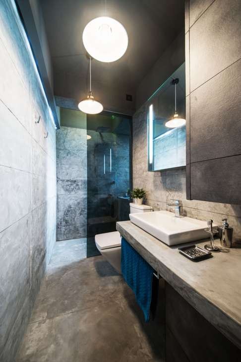 The concrete bathroom occupies the space of the original kitchen.