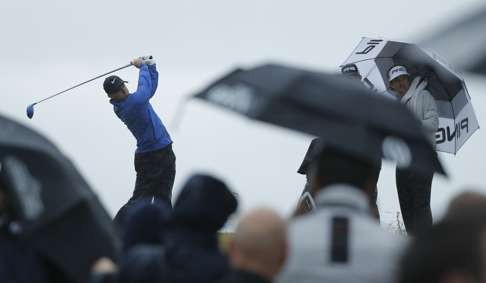 Rory McIlroy of Northern Ireland tees off the 13th hole watched by Bubba Watson of the United States, right. (AP Photo/Ben Curtis)