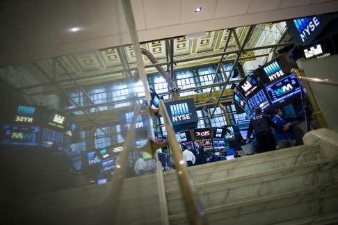 Traders work on the floor of the New York Stock Exchange (NYSE) as a rally in stocks coincided with strong US economic data. Photo: Bloomberg