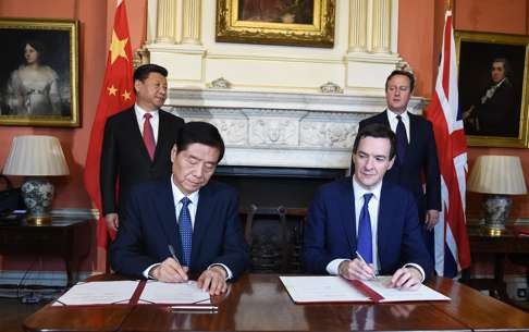 George Osborne signs a trade deal with China in London in October 2015 as President Xi Jinping and David Cameron look on. Photo: EPA