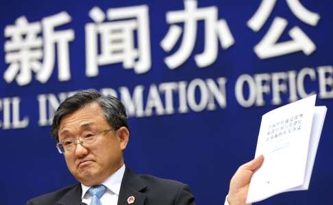 Chinese vice-minister for foreign affairs Liu Zhenmin holds up a policy paper on China’s position on the ruling during a press conference in Beijing last week. Photo: EPA