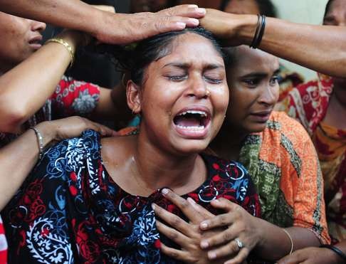 A relative of a worker killed in the 2013 collapse of a garment factory in Bangladesh reacts after identifying the body. A court charged 38 people with murder over the disaster that killed more than 1,100 people. The disaster highlighted appalling safety standards in Bangladesh’s US$28 billion garment export industry, the world's second largest after China. Photo: AFP