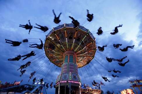 People swing on a ride during the Calgary Stampede in Alberta, Canada. Photo: Reuters