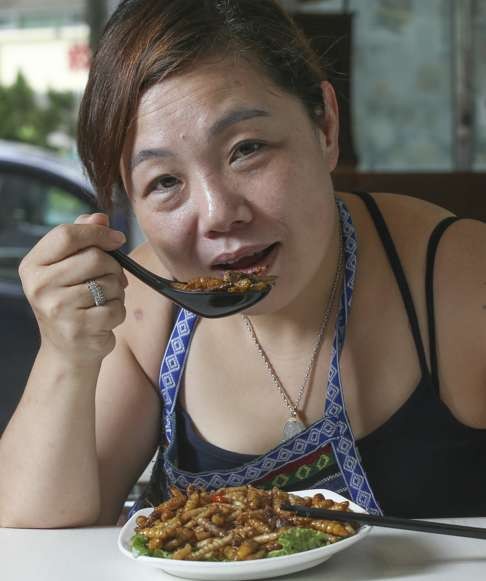 Amy Wong Ling, eating a dish of insects at her restaurant in San Po Kong. Photo: K.Y. Cheng
