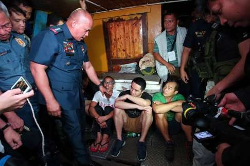 Philippine National Police chief Director General Ronald dela Rosa speaks to the arrested Hong Kong men who were found on a vessel-turned-floating-drug-laboratory at sea. Photo: EPA