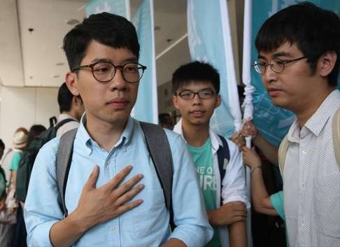 Law, with Wong and Chow, outside Eastern Court awaiting verdicts in their cases on Thursday. Photo: Sam Tsang